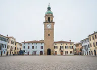 The same clock tower plaza with the tourists removed and the cobblestones filled in